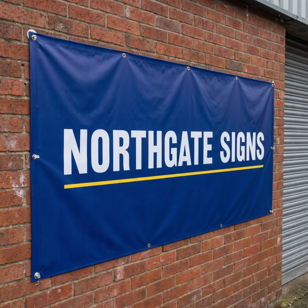PVC banner fixed flat to a brick wall